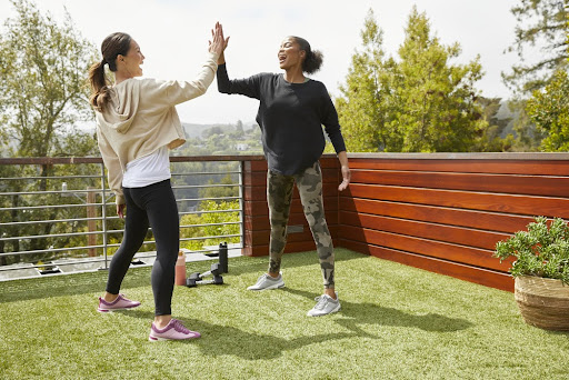Two women doing workout in the back yard