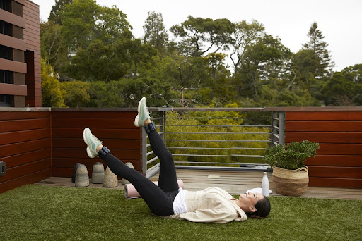 Woman exercising with leg weights