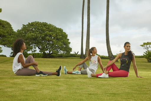 Group of friends training on the grass field