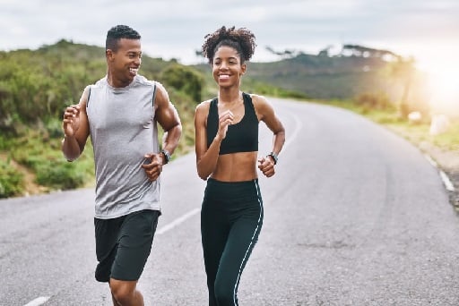 Shot of a sporty young couple exercising together outdoors.